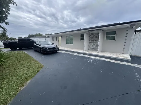 a view of a car parked in back of a house