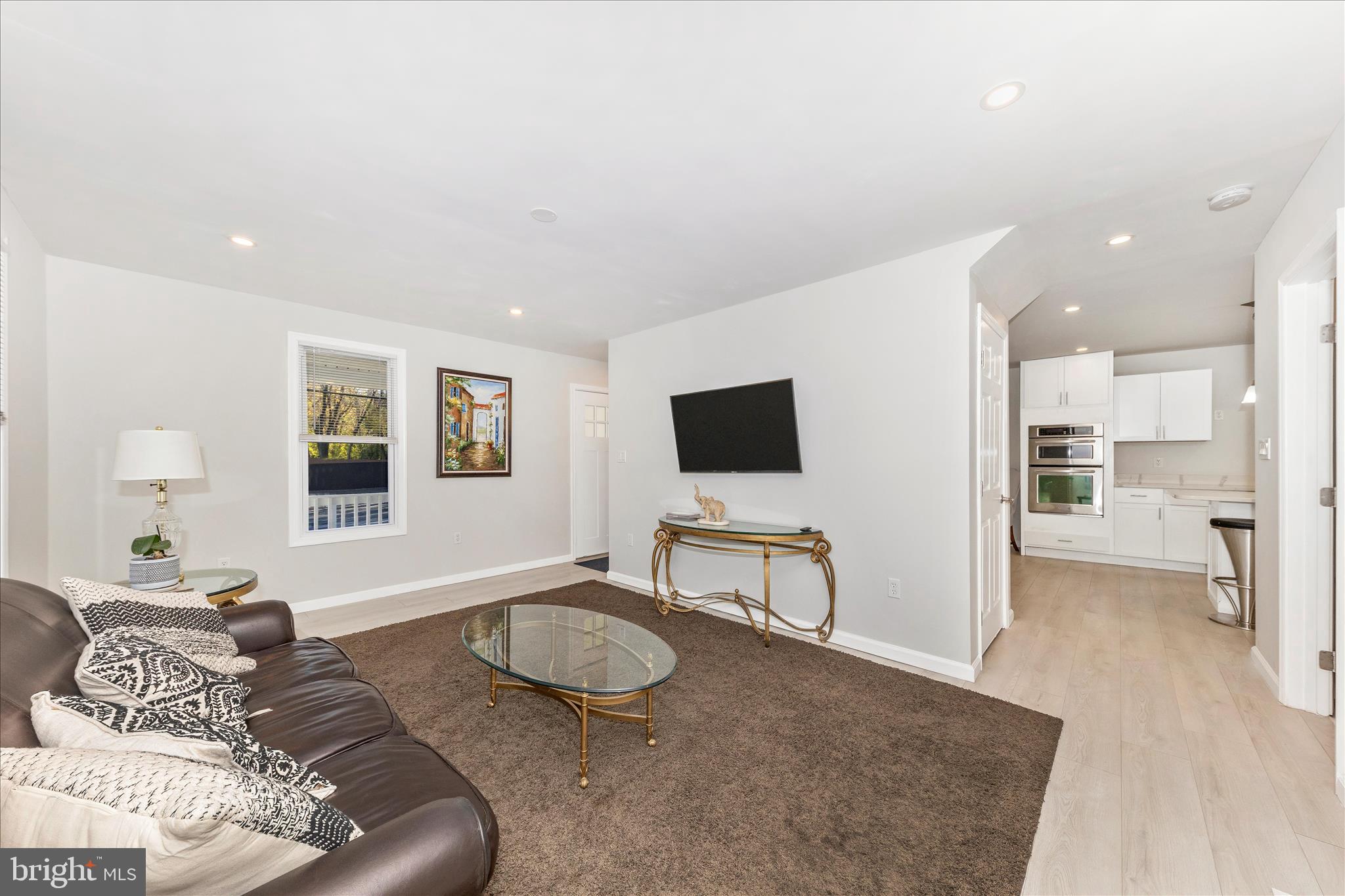 6216 Manor Woods Road Frederick, MD 21703 - Photo 12 of 45 a living room with furniture and a flat screen tv