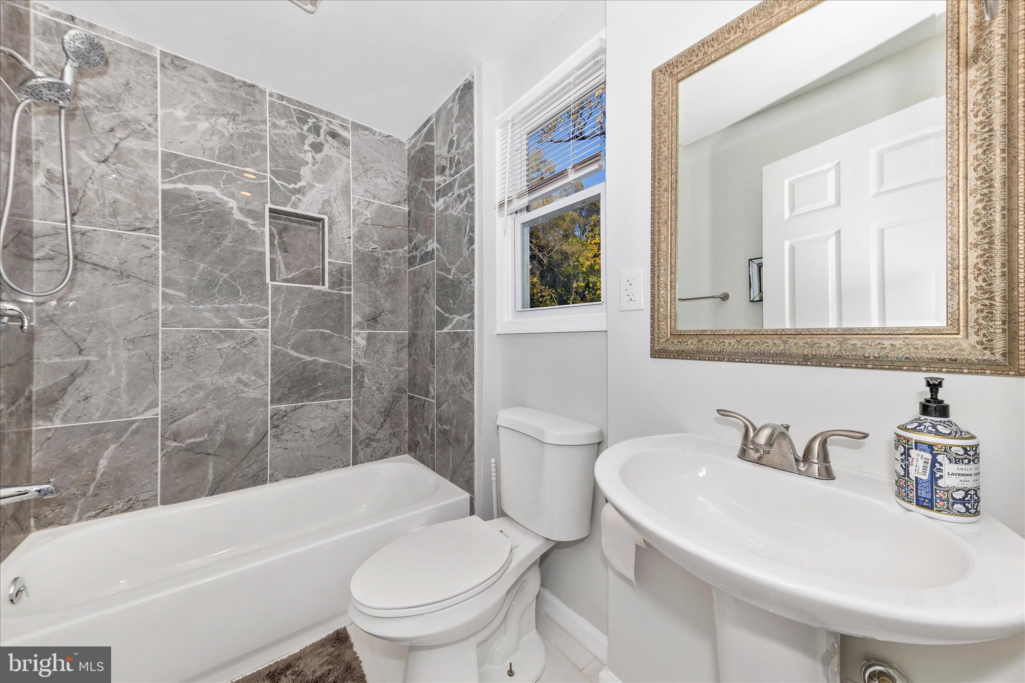 6216 Manor Woods Road Frederick, MD 21703 - Photo 15 of 45 a bathroom with a sink toilet and shower