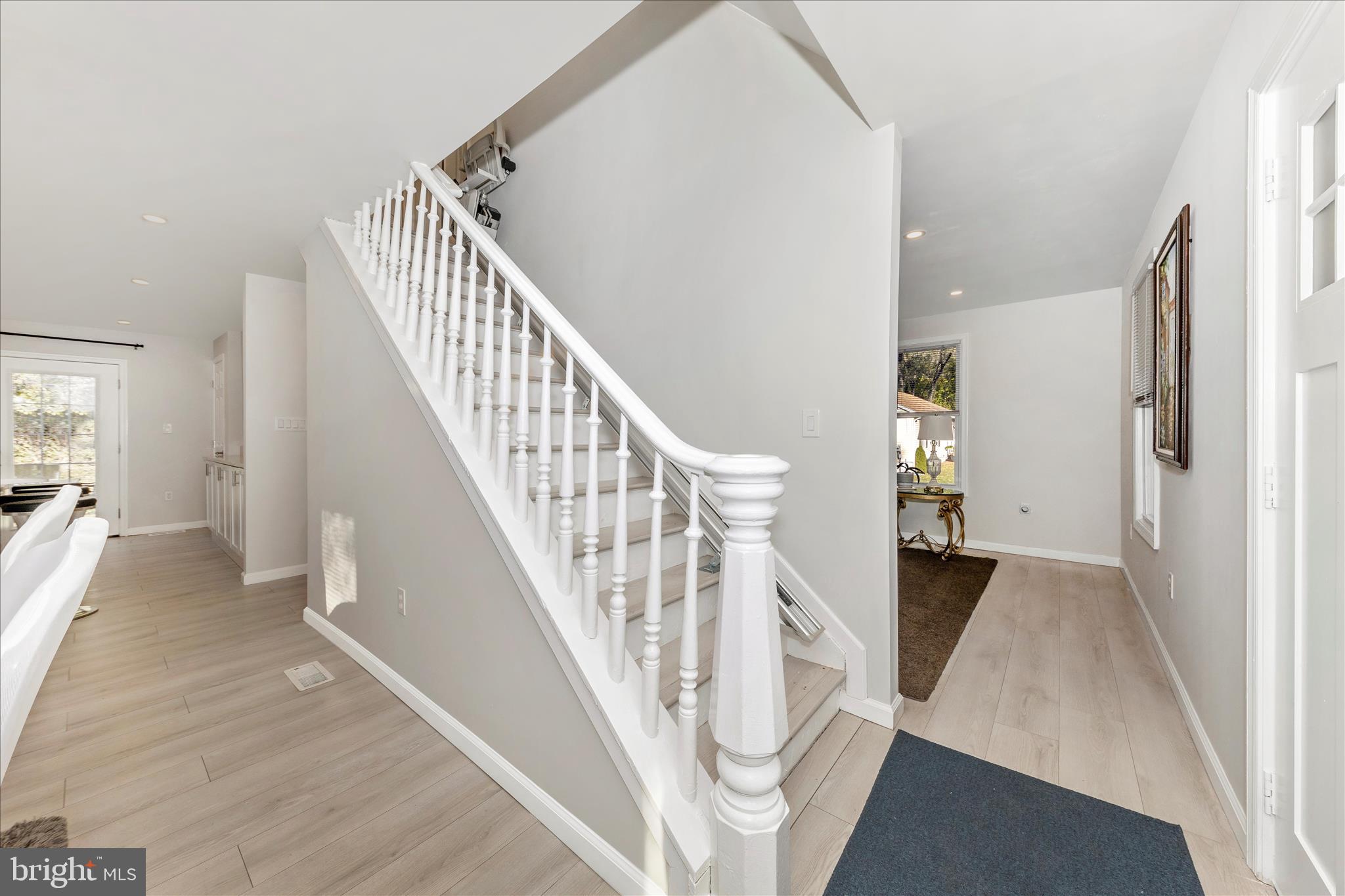 6216 Manor Woods Road Frederick, MD 21703 - Photo 17 of 45 a view of a hallway with wooden floor and staircase