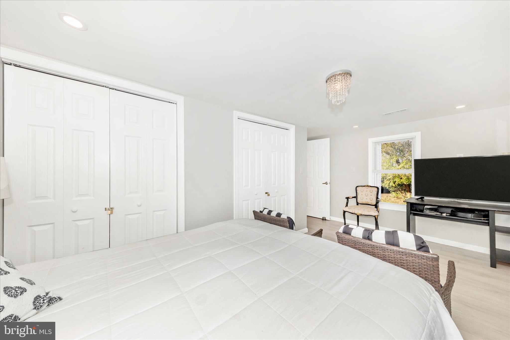 6216 Manor Woods Road Frederick, MD 21703 - Photo 21 of 45 a bedroom with a bed and a flat screen tv