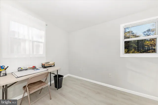 a room with a window and furniture