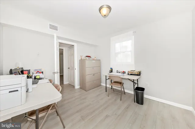a work room with furniture and wooden floor