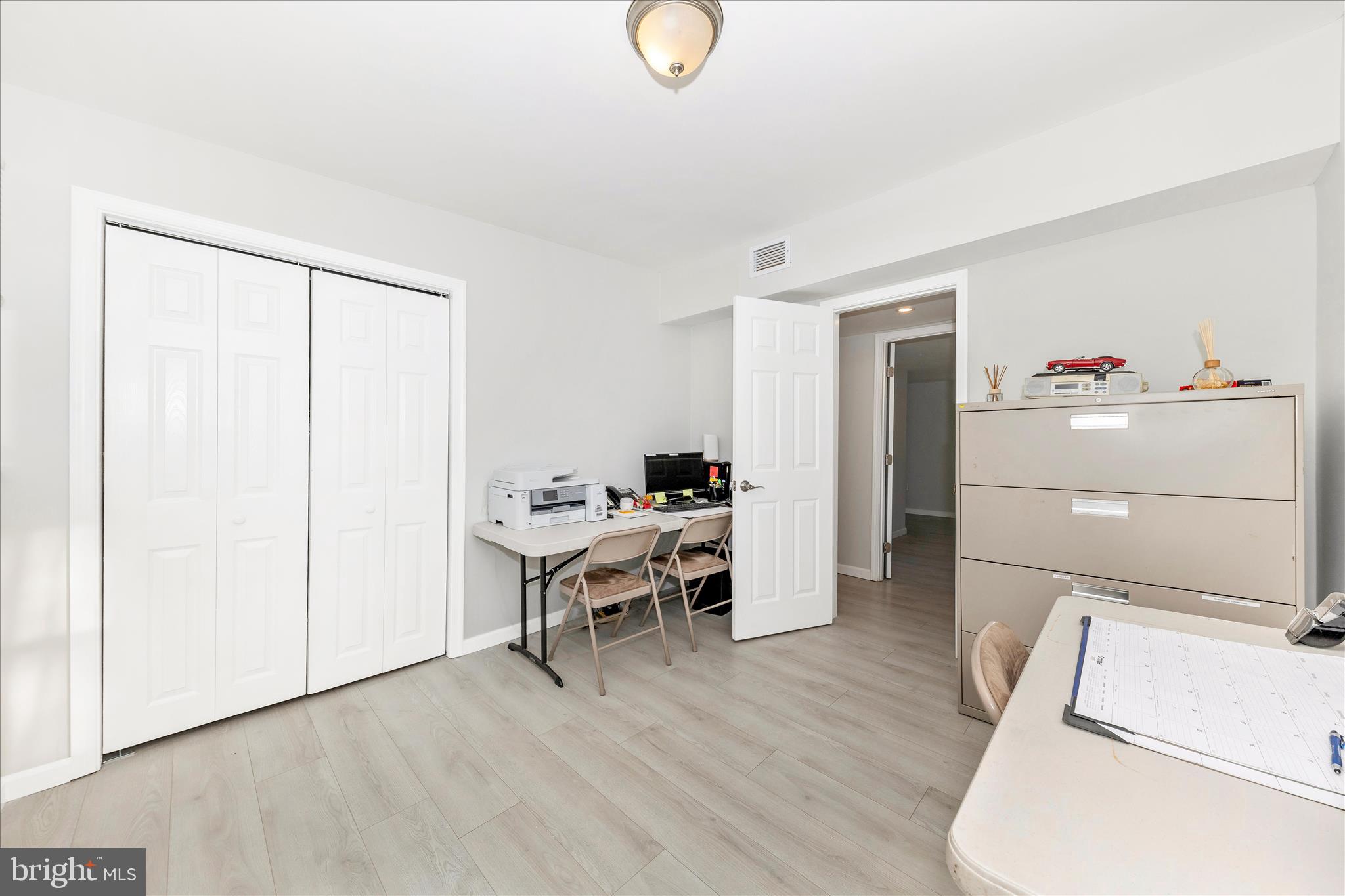 6216 Manor Woods Road Frederick, MD 21703 - Photo 25 of 45 a room with a wooden floor and a chair