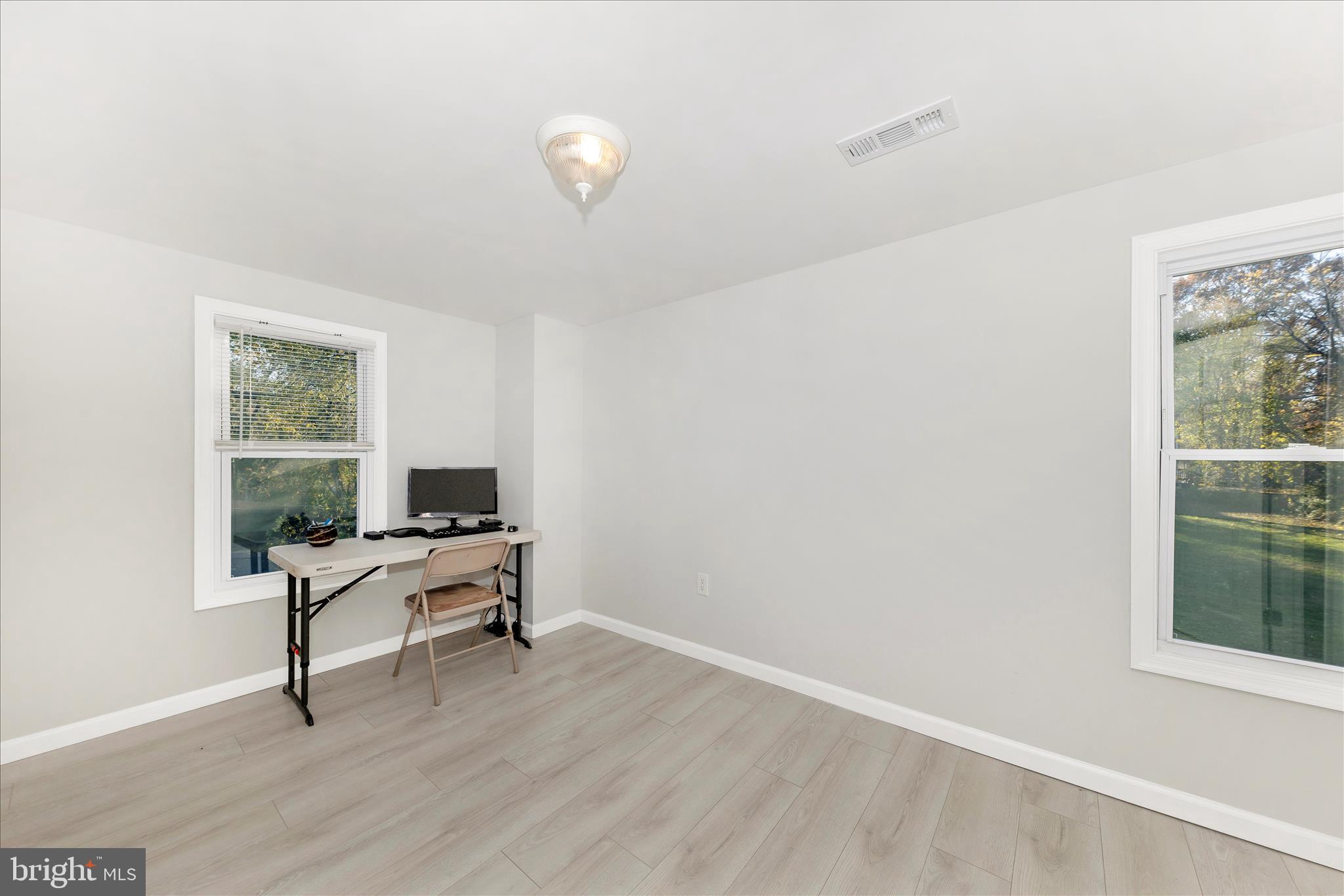 6216 Manor Woods Road Frederick, MD 21703 - Photo 27 of 45 a workspace with wooden floor and a window