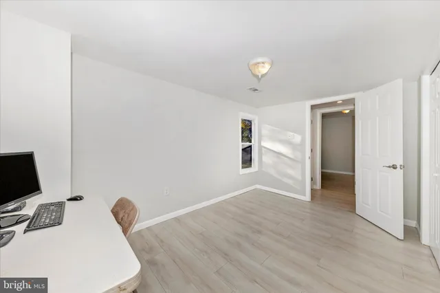 a view of a workspace with furniture and a flat screen tv