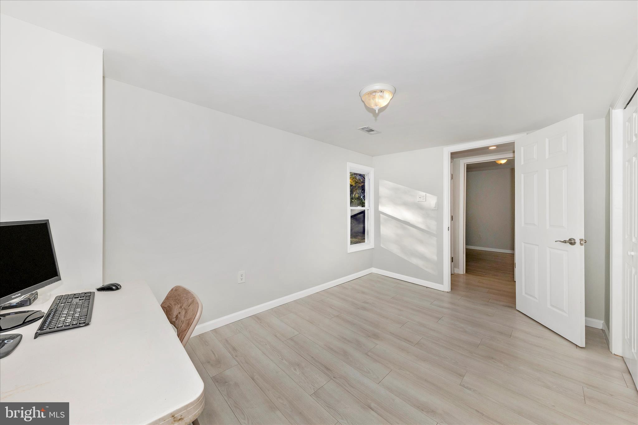 6216 Manor Woods Road Frederick, MD 21703 - Photo 29 of 45 a view of a workspace with furniture and a flat screen tv