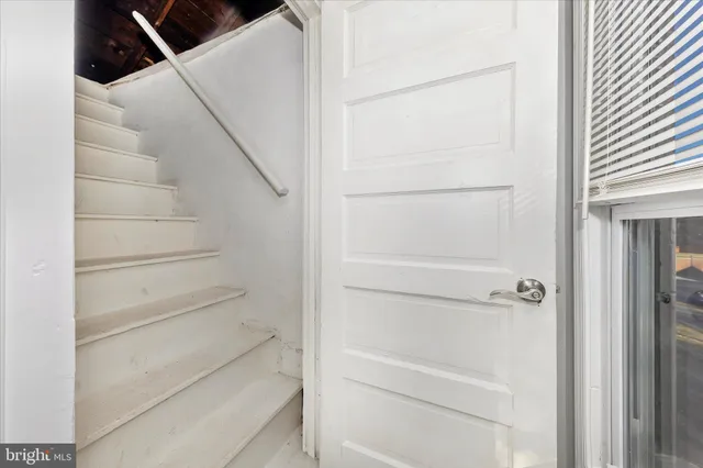 a view of staircase with white walls