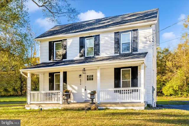 a house view with a swimming pool in front of it