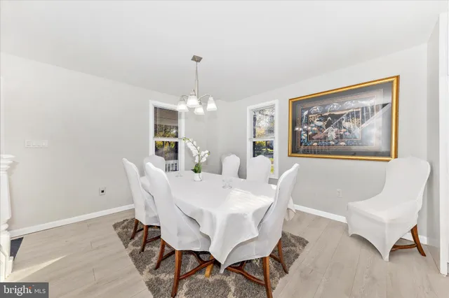 a view of a dining room with furniture and chandelier