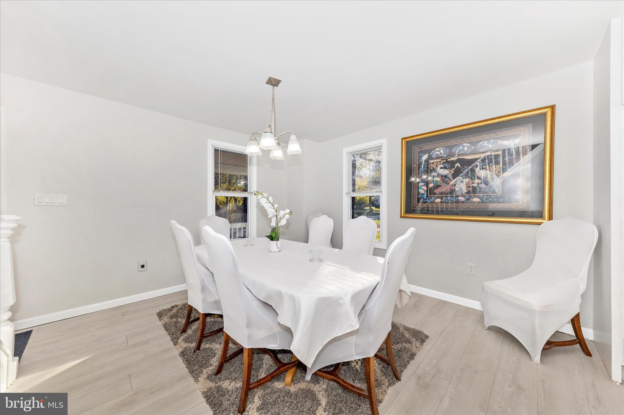 6216 Manor Woods Road Frederick, MD 21703 - Photo 7 of 45 a view of a dining room with furniture and chandelier