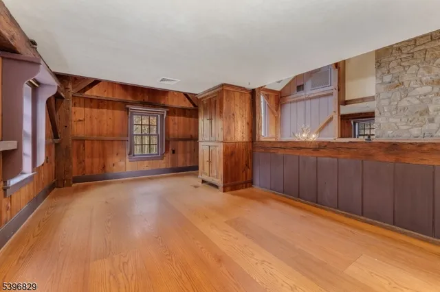 a view of empty room with wooden floor and cabinet