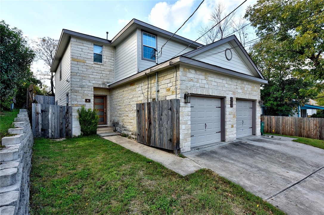a view of a house with a yard and garage