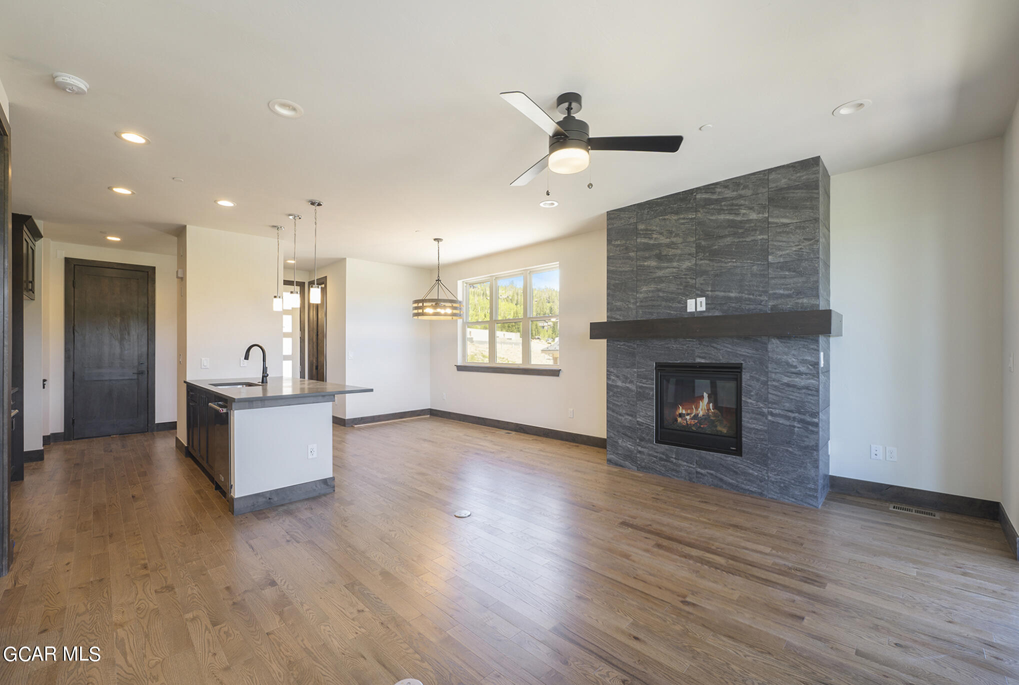119 Homestead Loop Fraser, CO 80442 - Photo 6 of 22 a large living room with a fireplace and wooden floor