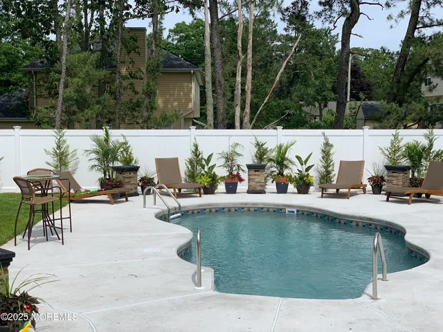 a view of a swimming pool with chairs