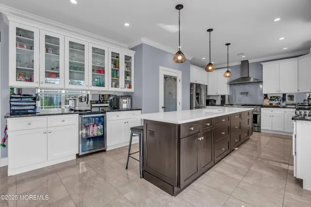 a kitchen with stainless steel appliances granite countertop a stove a sink a oven and a refrigerator