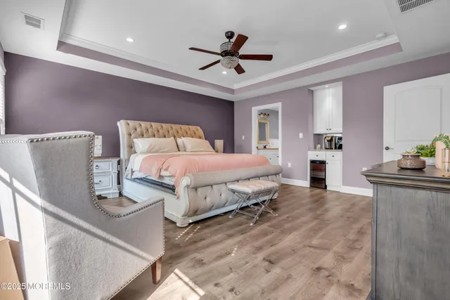 a spacious bedroom with a bed and a chandelier