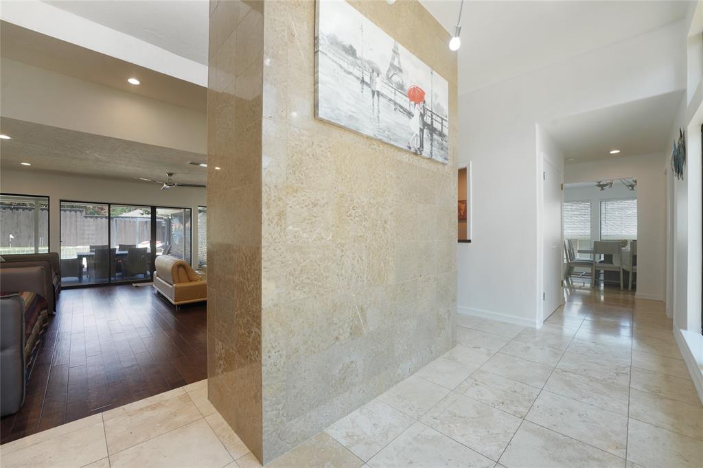 9677 Fallbrook Drive Dallas, TX 75243 - Photo 11 of 40 a view of a hallway with dining area and chandelier
