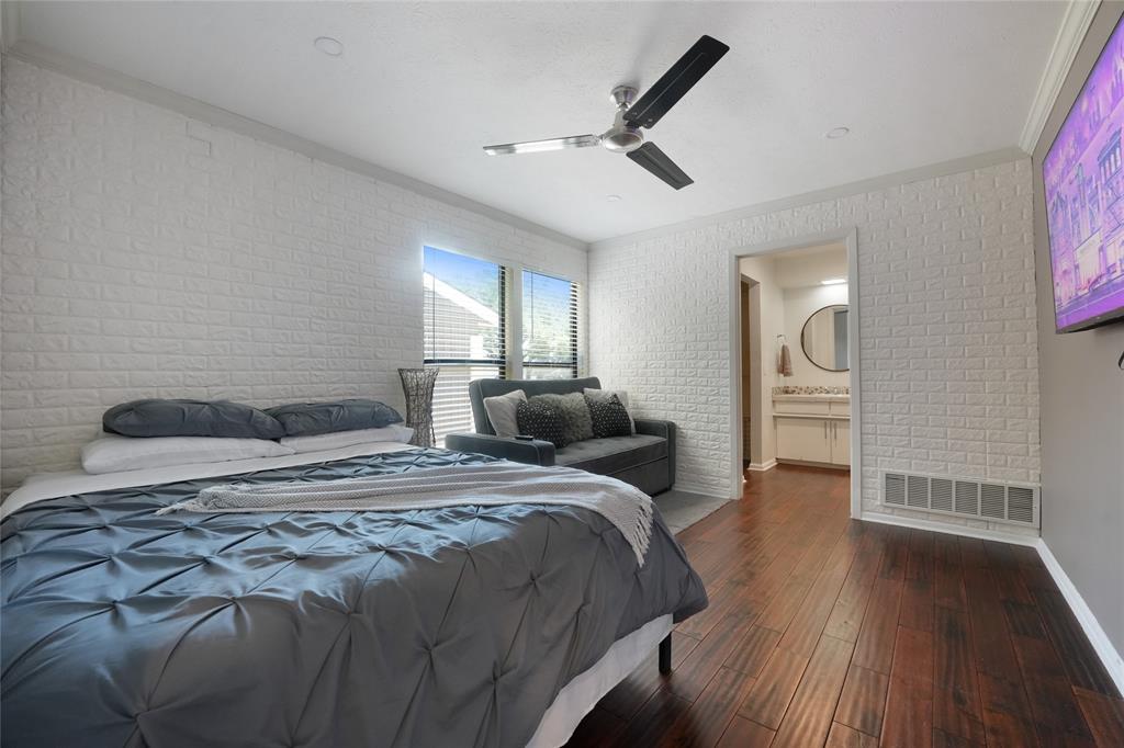 9677 Fallbrook Drive Dallas, TX 75243 - Photo 15 of 40 a spacious bedroom with a bed and wooden floor