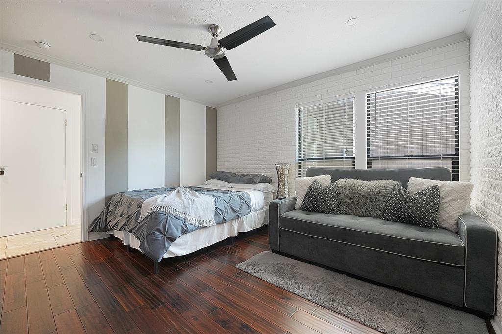 9677 Fallbrook Drive Dallas, TX 75243 - Photo 16 of 40 a bedroom with a bed couch and window