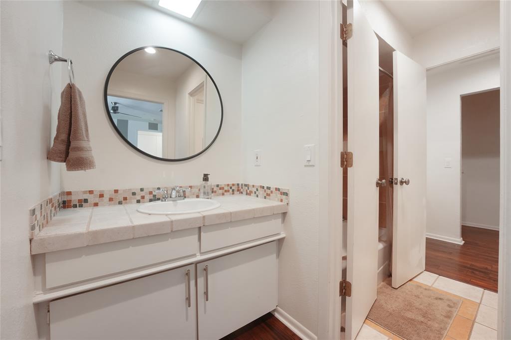 9677 Fallbrook Drive Dallas, TX 75243 - Photo 17 of 40 a bathroom with a sink and a mirror