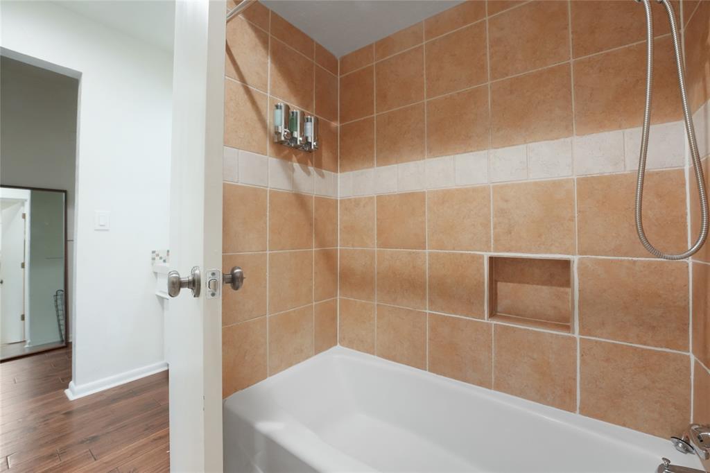 9677 Fallbrook Drive Dallas, TX 75243 - Photo 18 of 40 a bathroom with a bathtub and shower