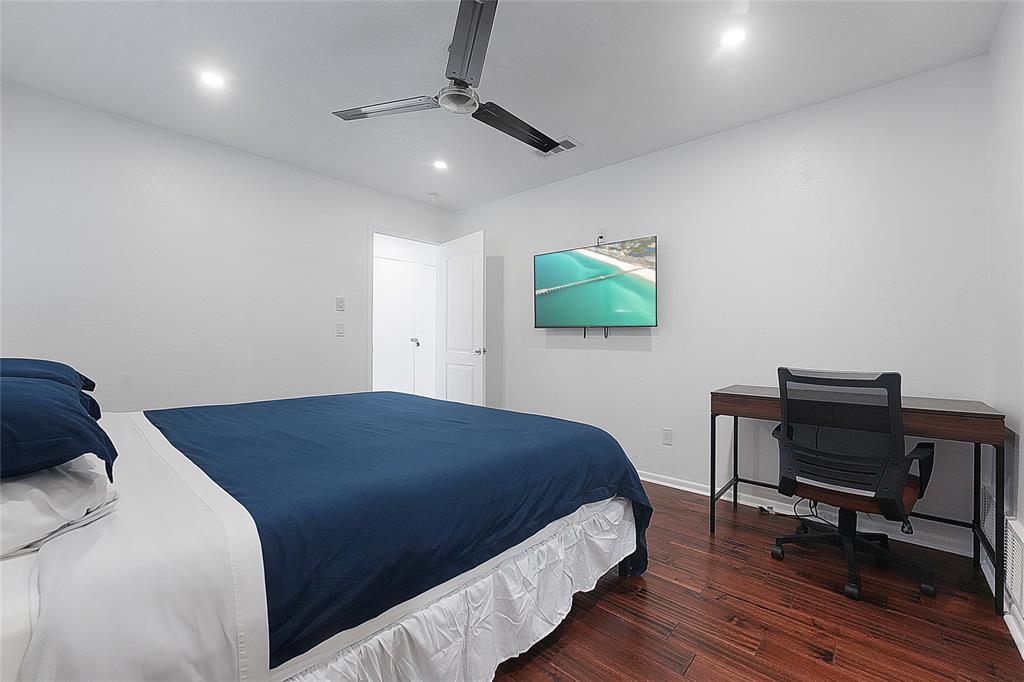 9677 Fallbrook Drive Dallas, TX 75243 - Photo 20 of 40 a bedroom with a bed table and a chair