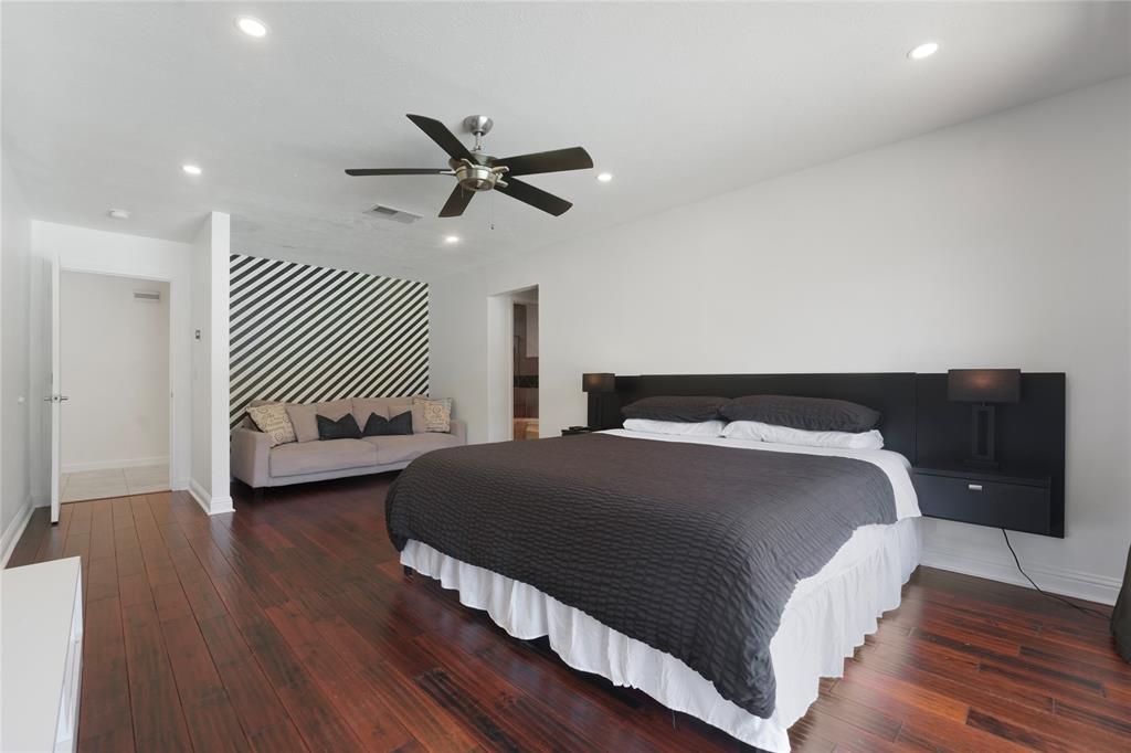 9677 Fallbrook Drive Dallas, TX 75243 - Photo 22 of 40 a bedroom with a bed and wooden floor