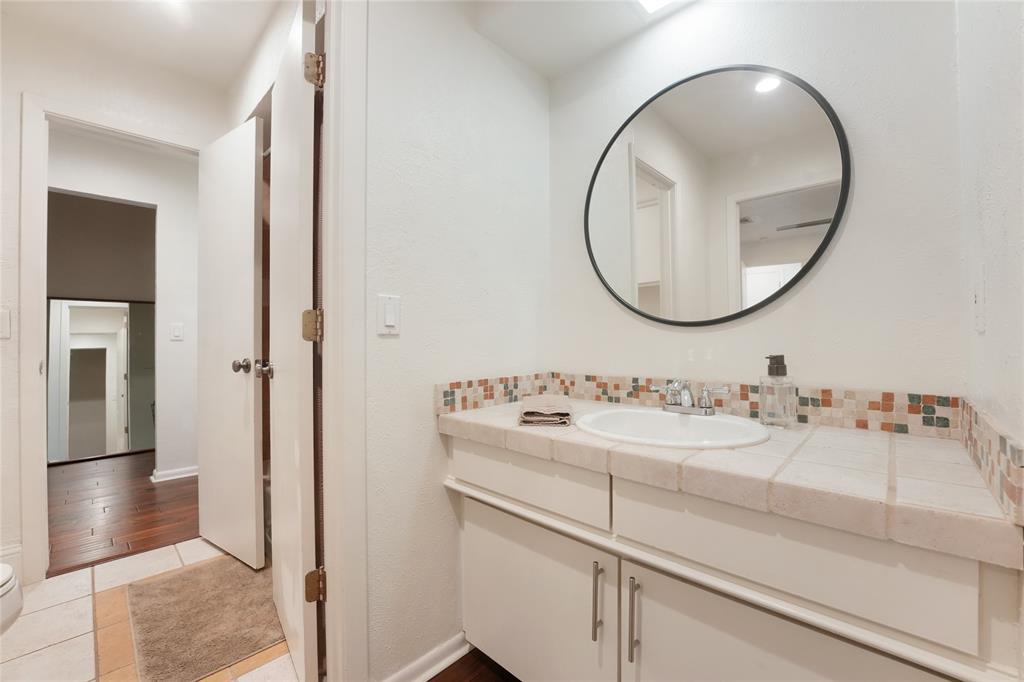 9677 Fallbrook Drive Dallas, TX 75243 - Photo 23 of 40 a bathroom with a sink and a mirror