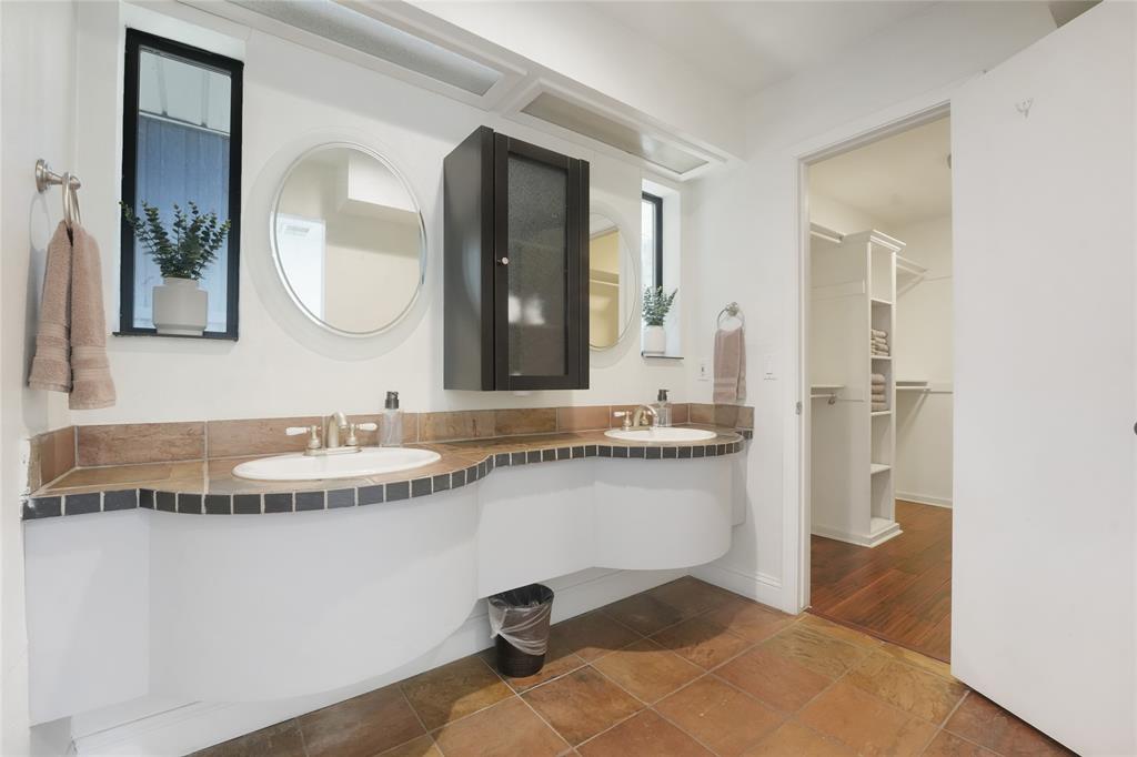 9677 Fallbrook Drive Dallas, TX 75243 - Photo 24 of 40 a bathroom with a granite countertop sink and a mirror