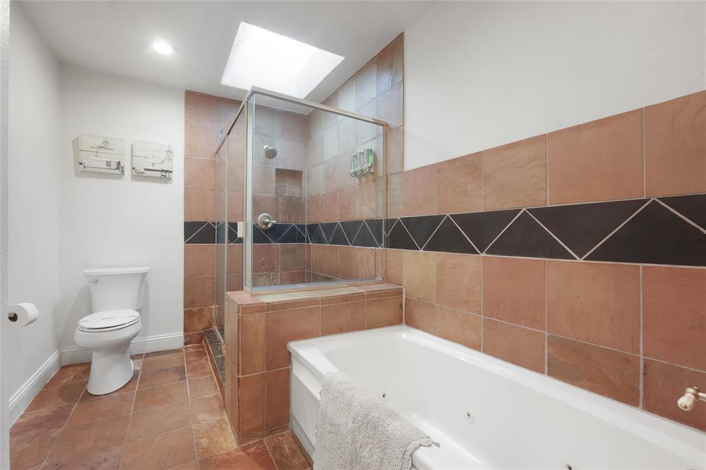 9677 Fallbrook Drive Dallas, TX 75243 - Photo 25 of 40 a bathroom with a sink a toilet and shower