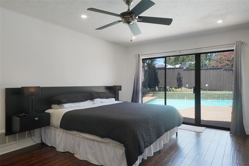 9677 Fallbrook Drive Dallas, TX 75243 - Photo 29 of 40 a bedroom with a large bed and a large window