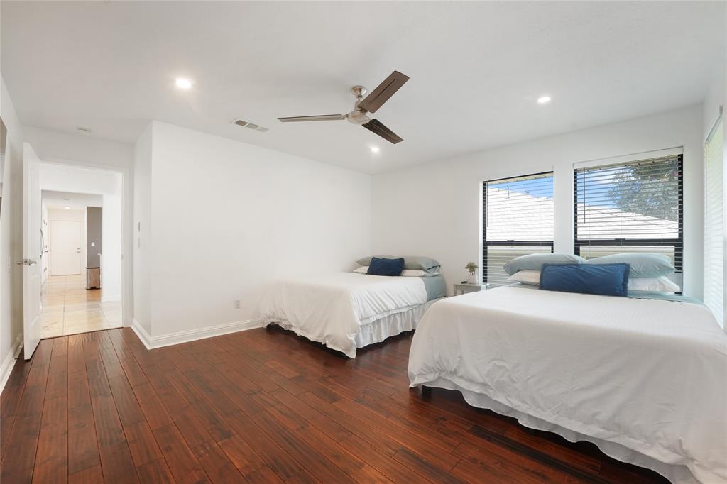 9677 Fallbrook Drive Dallas, TX 75243 - Photo 31 of 40 a bedroom with two beds and a chandelier