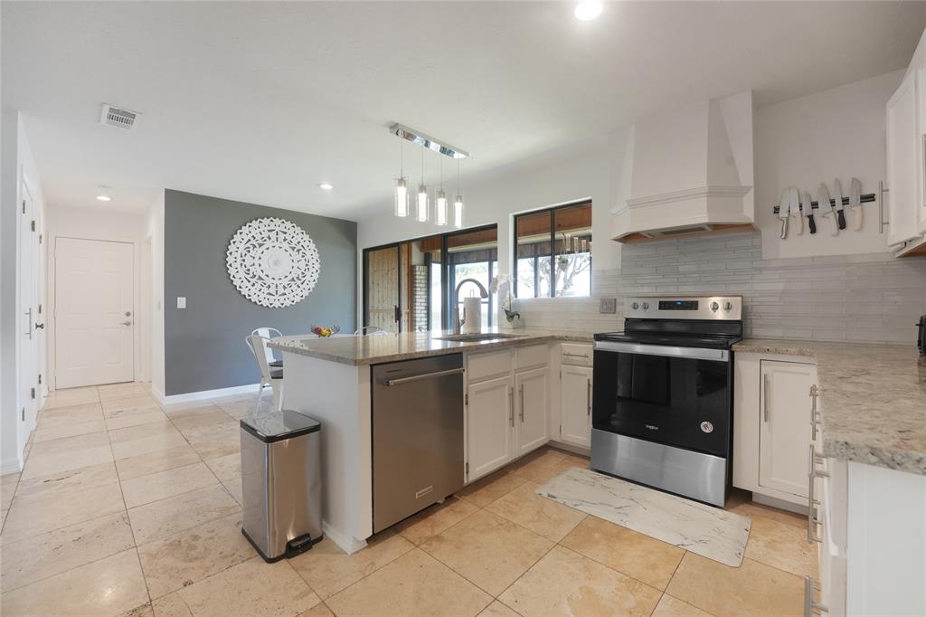 9677 Fallbrook Drive Dallas, TX 75243 - Photo 33 of 40 a kitchen with granite countertop a sink and a stove top oven