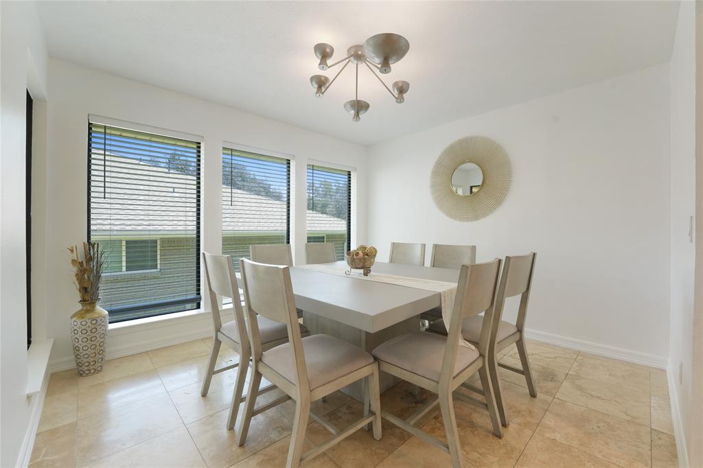 9677 Fallbrook Drive Dallas, TX 75243 - Photo 5 of 40 a view of a dining room with furniture and a large window