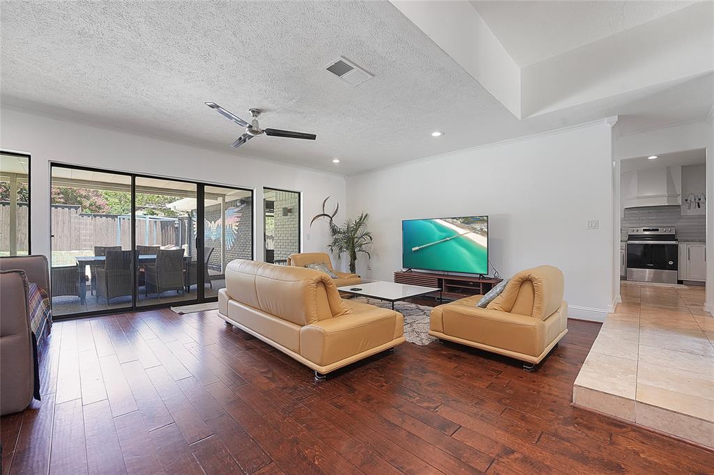 9677 Fallbrook Drive Dallas, TX 75243 - Photo 6 of 40 a living room with furniture and a flat screen tv
