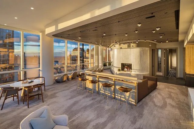 a living room with furniture and a floor to ceiling window