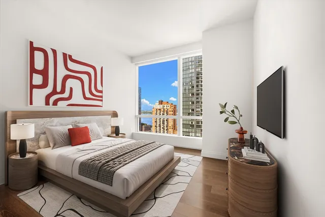 a bedroom with a bed and a flat screen tv