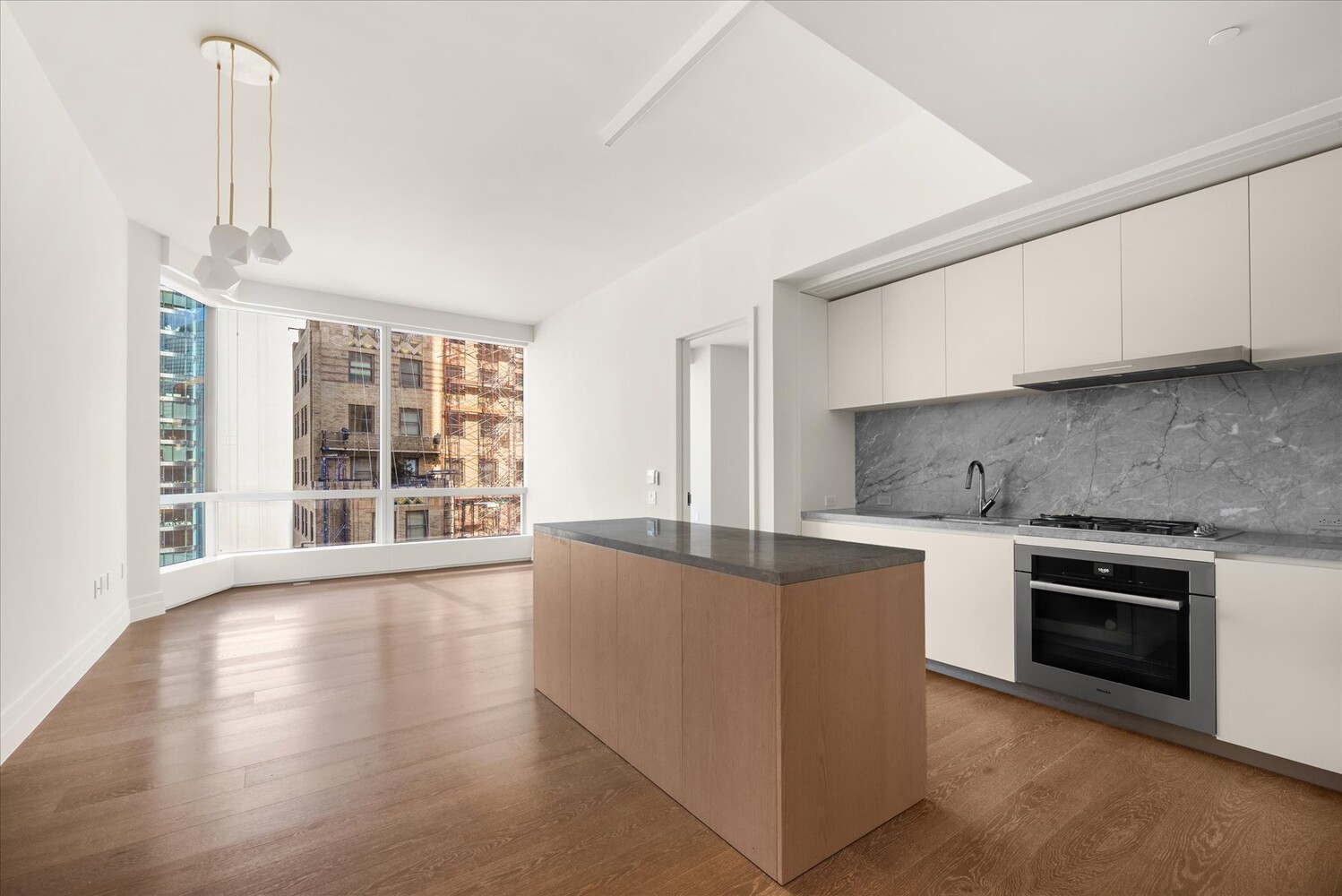 77 Greenwich Street, Unit 23C Manhattan, NY 10006 - Photo 5 of 18 a kitchen with stainless steel appliances granite countertop a stove and a sink