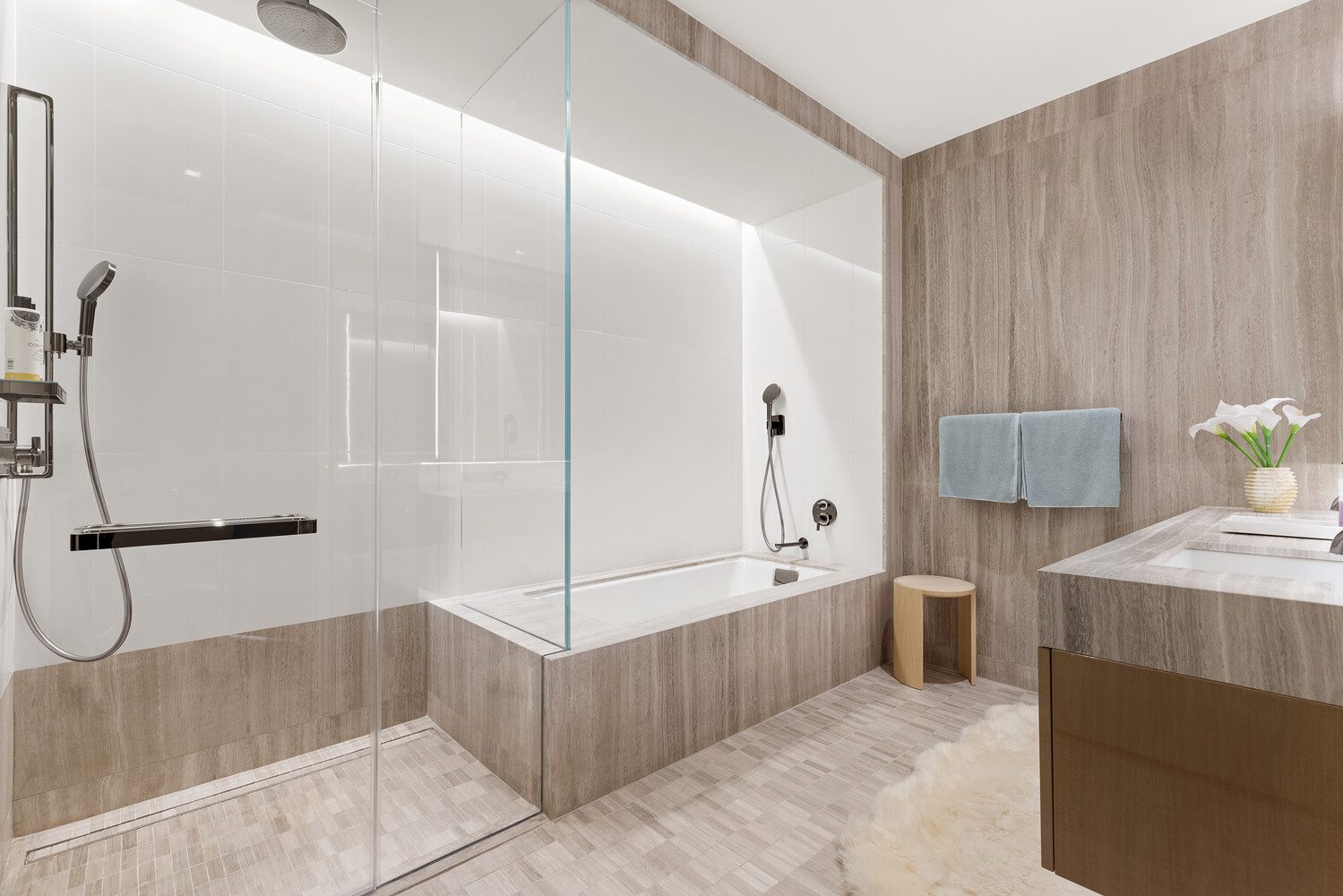 77 Greenwich Street, Unit 23C Manhattan, NY 10006 - Photo 7 of 18 a bathroom with a tub shower and sink