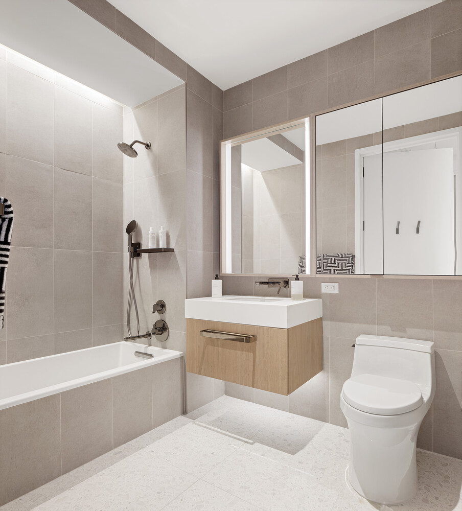 77 Greenwich Street, Unit 23C Manhattan, NY 10006 - Photo 9 of 18 a bathroom with a tub sink and mirror