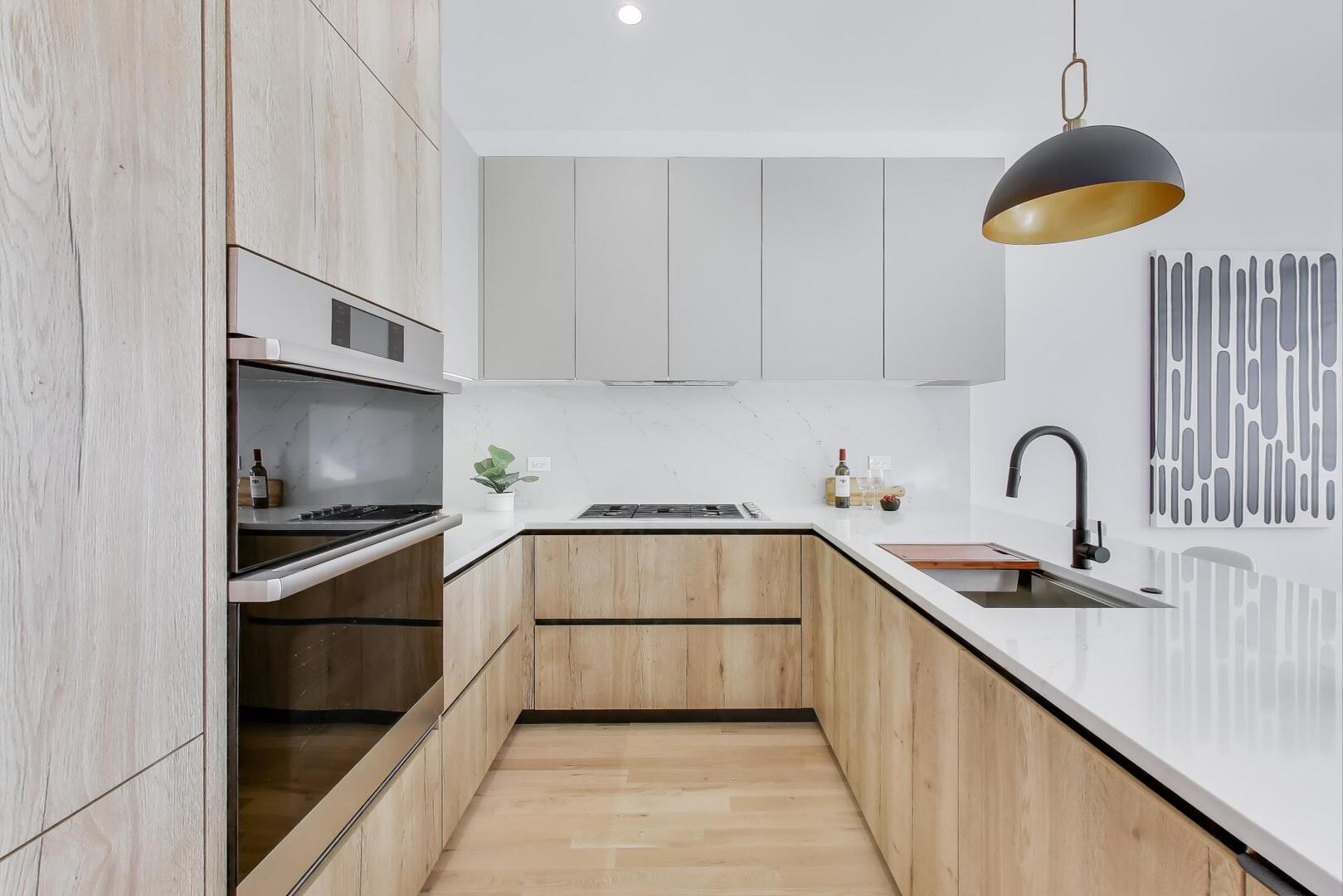 2456 West Cortez Street, Unit 3E Chicago, IL 60622 - Photo 14 of 46 a kitchen with stainless steel appliances a stove sink and cabinets