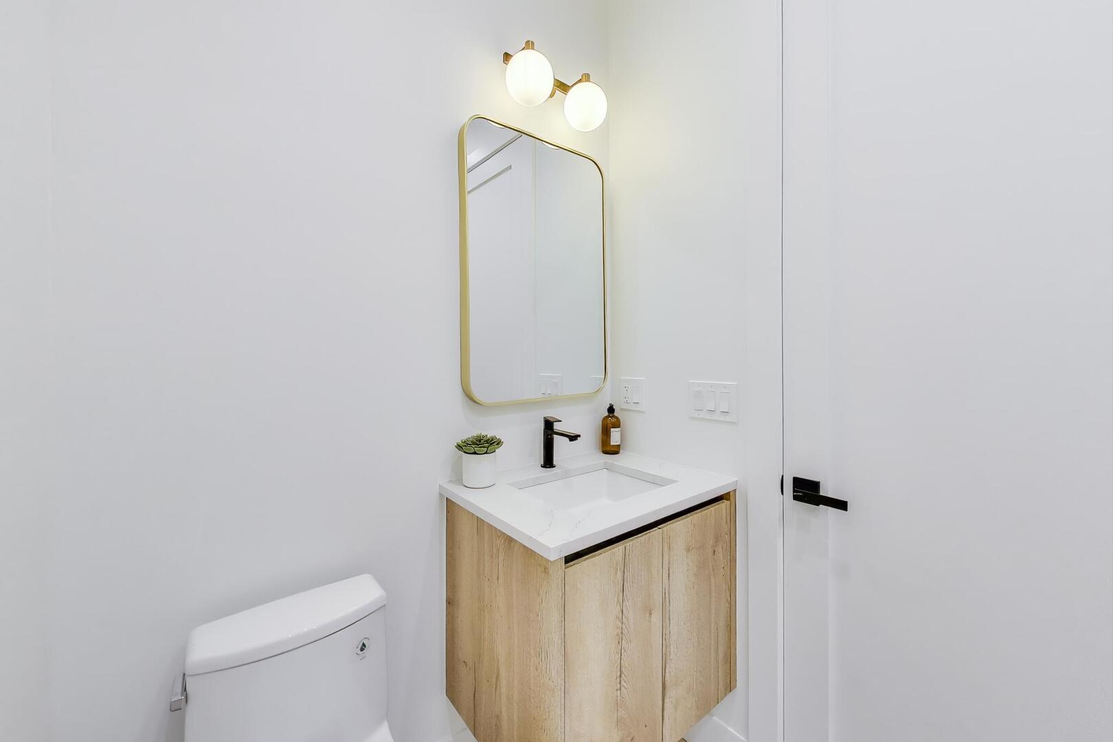 2456 West Cortez Street, Unit 3E Chicago, IL 60622 - Photo 26 of 46 a bathroom with a sink vanity mirror and toilet