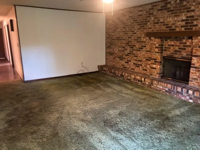 a view of an empty room and fire place
