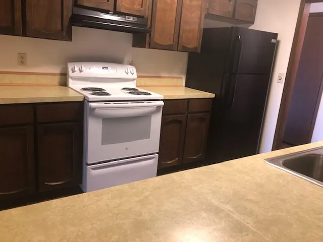 a kitchen with a stove and a refrigerator