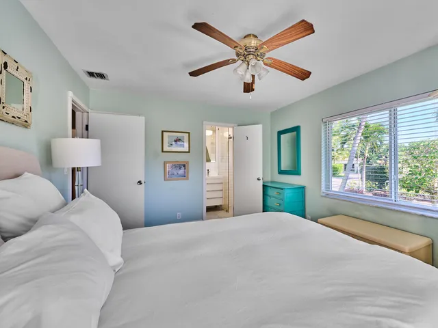 a bedroom with a large bed and a large window