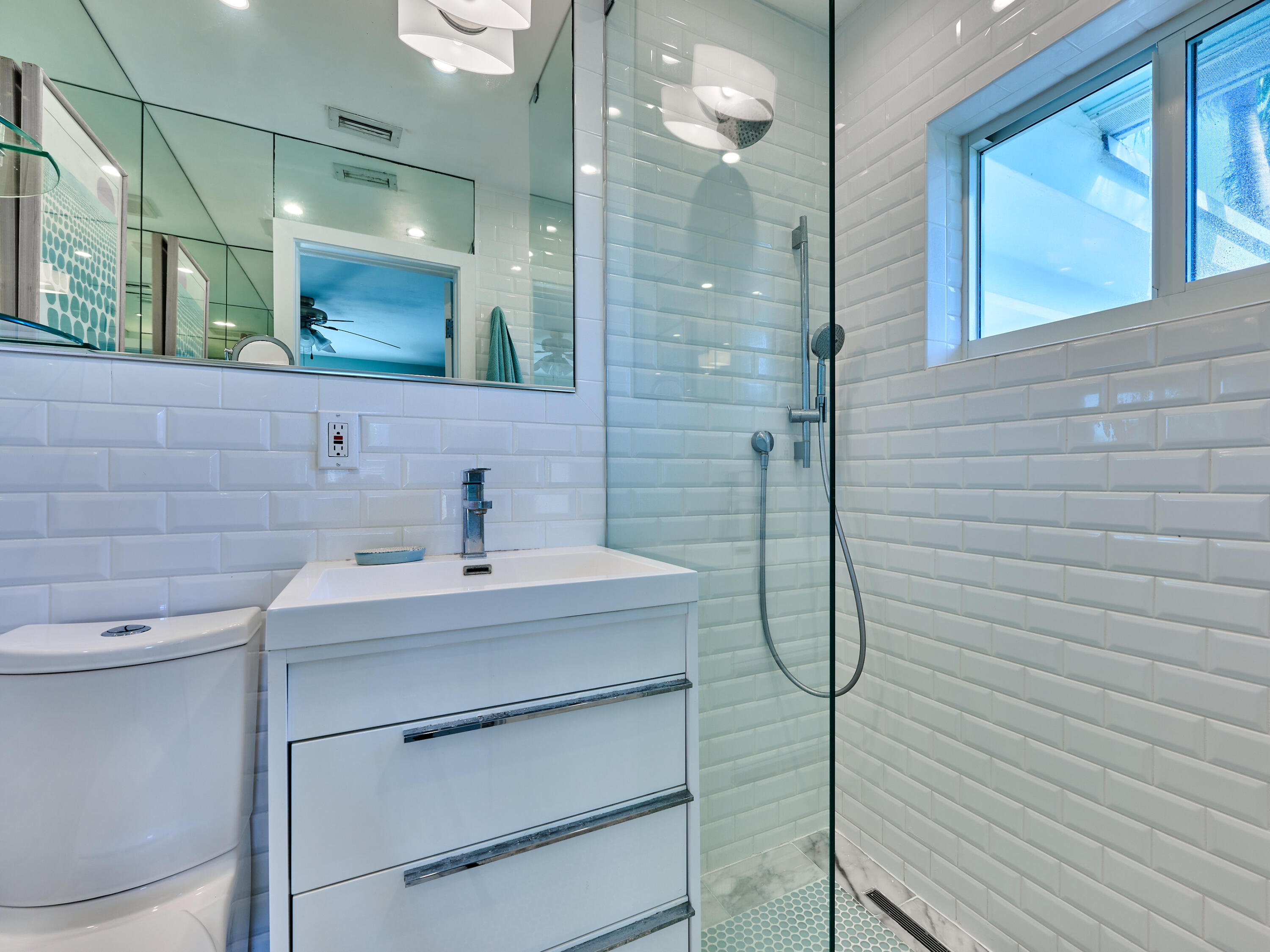 301 Northwest 3rd Court Boca Raton, FL 33432 - Photo 13 of 45 a bathroom with a sink vanity and a mirror