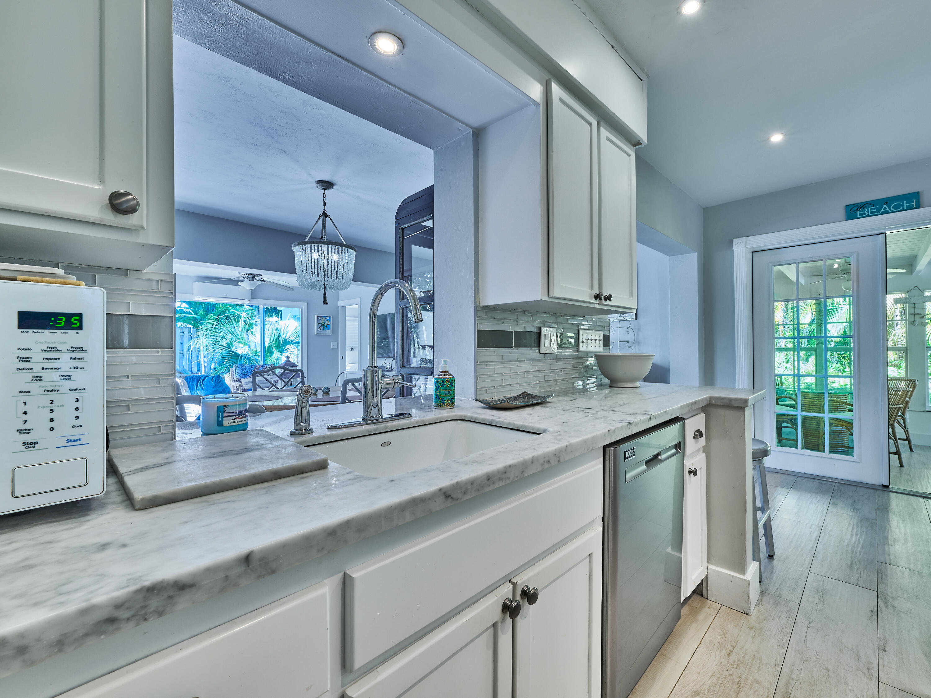 301 Northwest 3rd Court Boca Raton, FL 33432 - Photo 18 of 45 a kitchen with stainless steel appliances granite countertop a sink a stove and cabinets