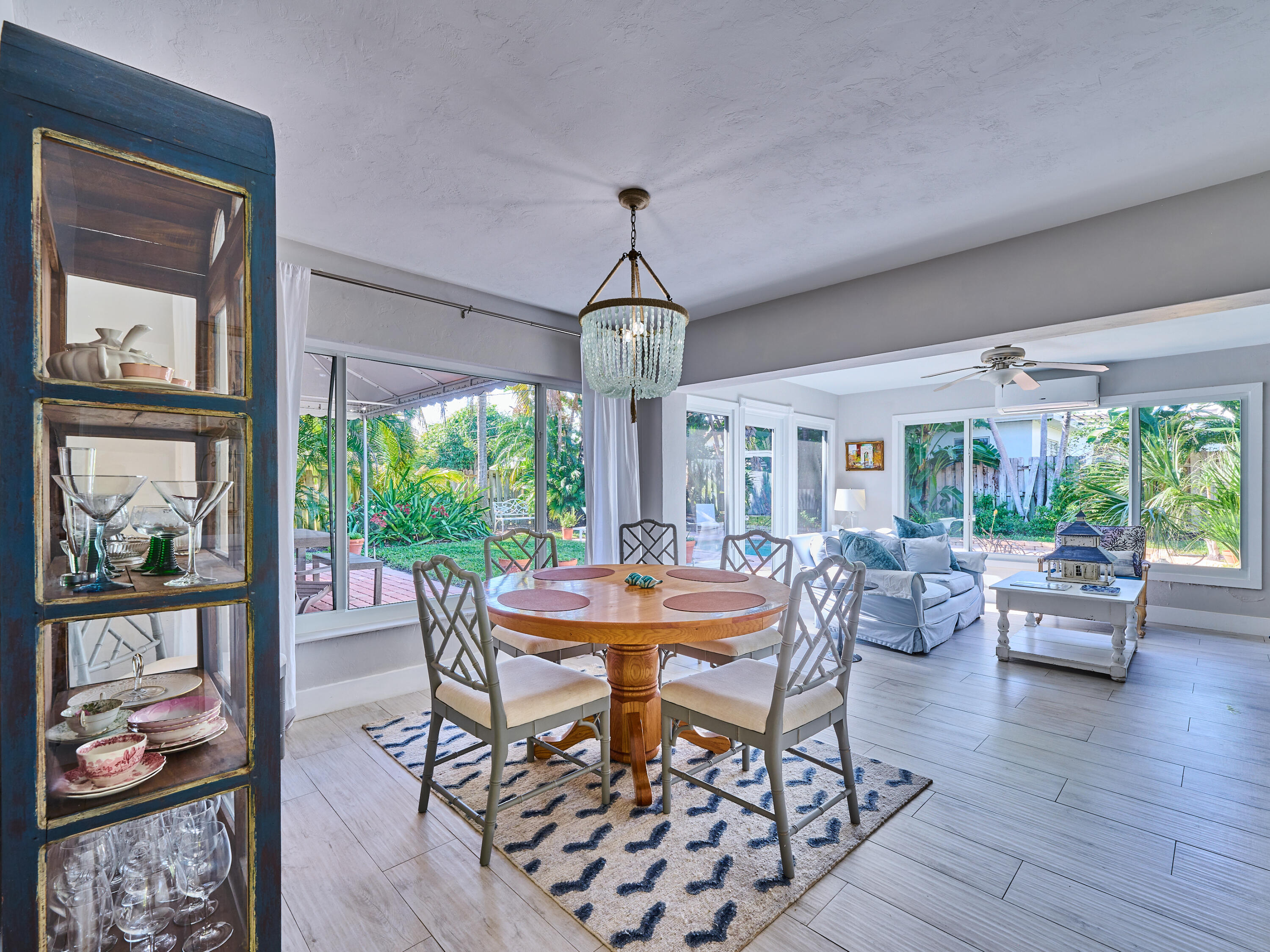 301 Northwest 3rd Court Boca Raton, FL 33432 - Photo 21 of 45 a dining room with wooden floor a chandelier a wooden table and chairs