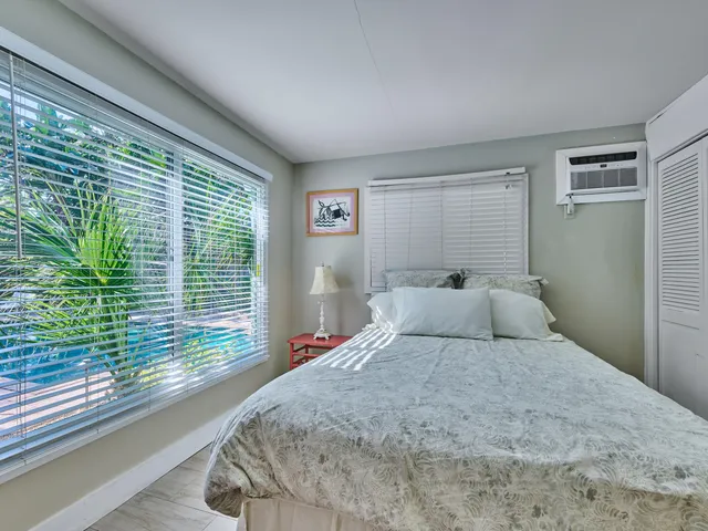 a bedroom with a large bed and a large window